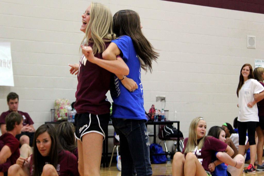 Junior Carly Moore and a Taylor High School student team up for a partnering exercise during PALS training day on September 12th. Students from Cinco Ranch, Seven Lakes, and Taylor High Schools all came to participate in the PALS training held in the ninth grade gym