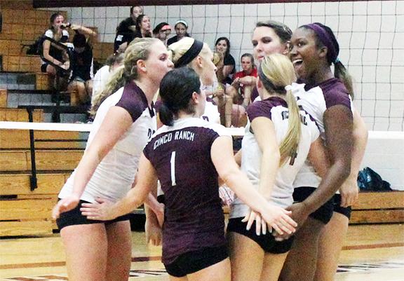 The Lady Cougars celebrate after winning a point against Memorial. However, the Cougars lost the match up 2-1.