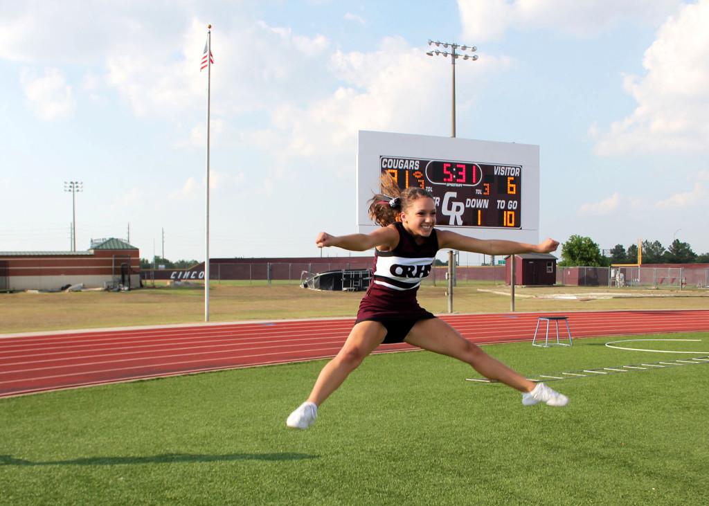 Junior Cynthia Torrence in midair during a toe touch jump.  Torrence is a second year Junior Varisity cheerleader for Cinco Ranch High School. 