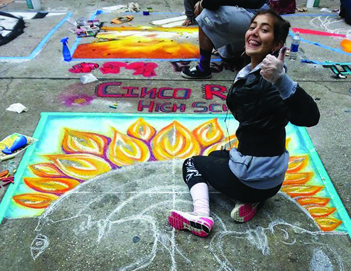 Anuska+Martinez+giving+the+thumbs+up+as+she+completes+her+chalk+mural.+The+festival+lasted+two+days+which+allowed+her+more+time+to+work.