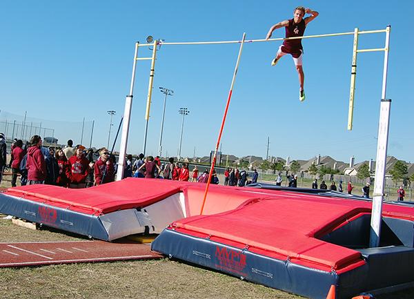 Steven Nixon completes his performance in pole-vaulting at the district meet for Track and Field.