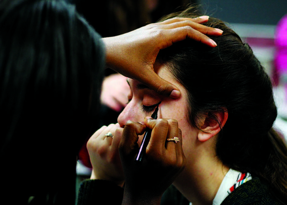 Junior Courtney Morris applies makeup to senior Julia Riffle on one of the club’s events, Cosmetology Day.