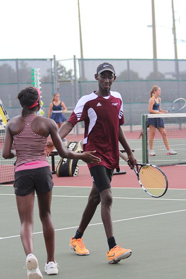 Siblings+Yoma+and+Suvweh+congratulate+each+other+after+a+play+during+the+district+championship+on+September+30th.