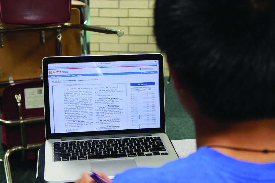 Junior David Dinh works on his “Quest” physics homework. Trouble with access can make these assignments a burden.