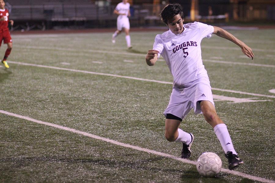 Sophomore Nic Fielden reaches for the ball during a district match against Katy on March 20.