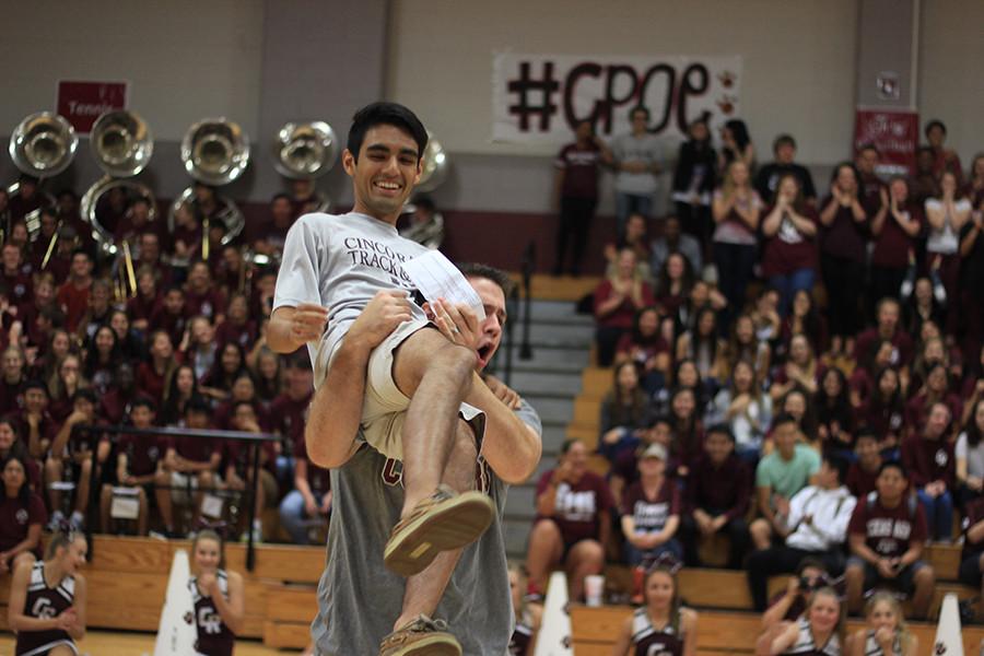 Math teacher Steven Fish congratulates junior Paul Vigil after winning the intense Kleenex tissue contest at Fridays pep rally. Fall sports teams were introduced as students packed the competition gym Friday during 2nd and 3rd periods.