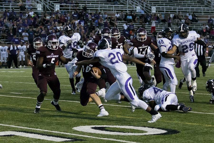 Senior QB Russell Morrison cuts through the Morton Ranch defense. Morrisons dual threat passing and running led the Cougars to a 34-7 win in District 19-6A competition. Varsity improves to 5-0 (2-0) on the season.