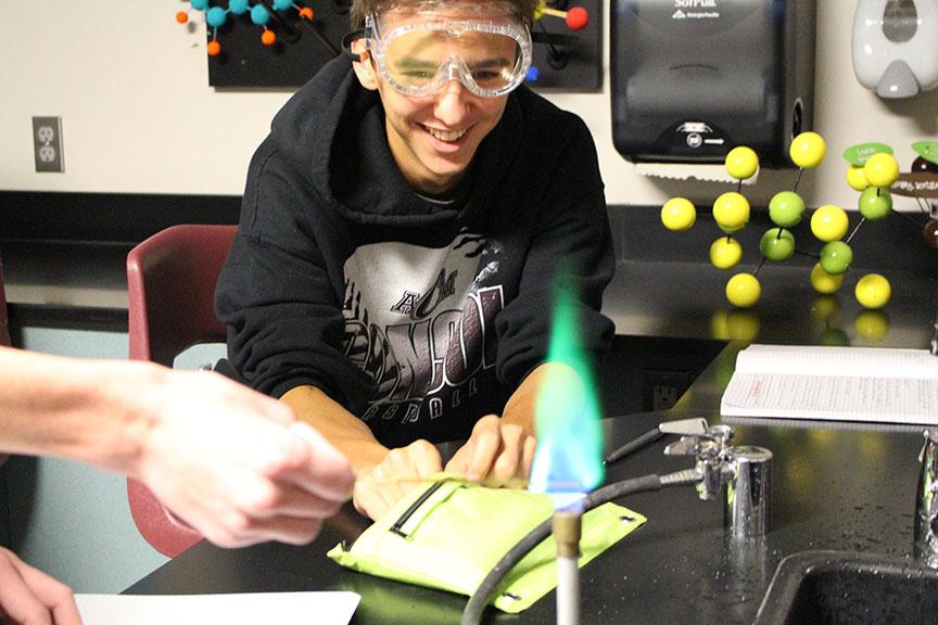 Sophomore Matthew Haigwood observes the color change from a distance. All the students in the class were amazed by the vibrant colors the chemical solutions gave off. 