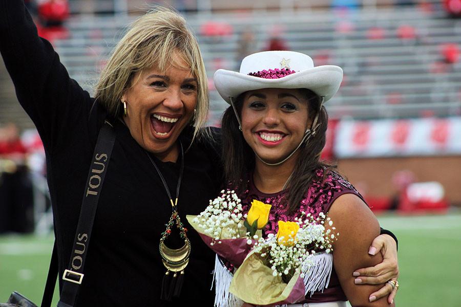 Senior Cougar Star Debbie Wooding celebrates her last district game with her mom at halftime, commemorating all the years that she danced for her school. (Reagan Bunch)