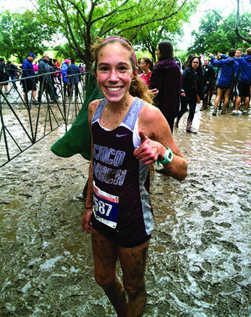 Reagan Kappel poses for a quick picture after running the 5K on a tough, muddy course. 