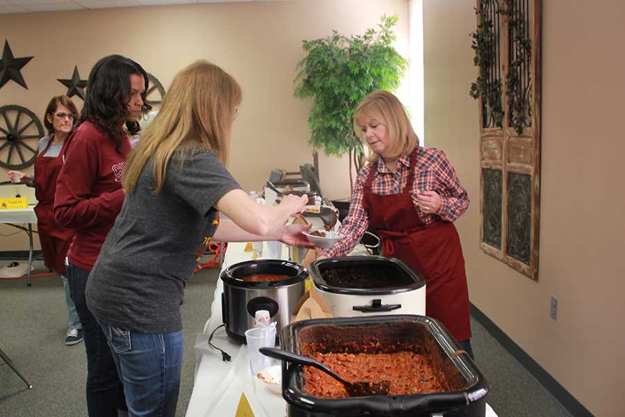 Associate Principal Patti Smith serves up tasting cups for the faculty chili cook-off Monday.