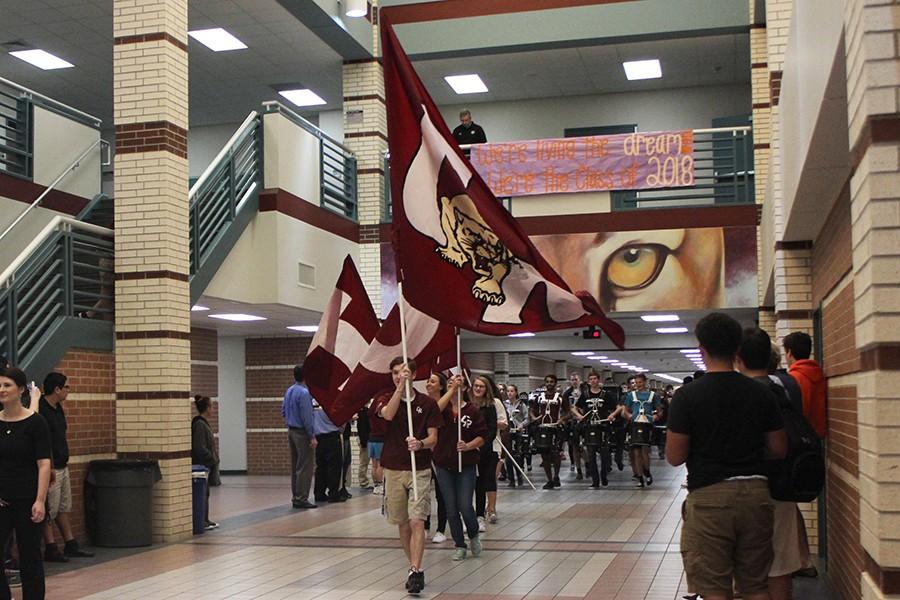Ranch Hands lead the sendoff through the hallway as students crowd to see the swimmers and wrestlers who are on their way to state.  The sendoff occurred on Feb. 18. 