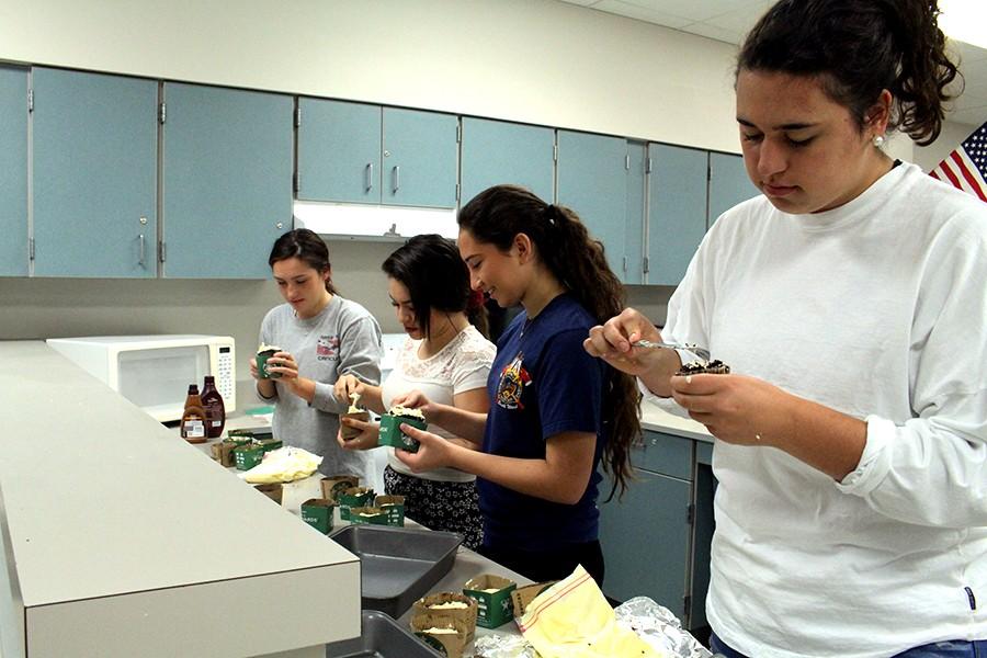 Juniors Julia Douglas, Venae Gonzalez, Bianca Chavez, and Angela Franco begin the decorating process of their cupcakes. 