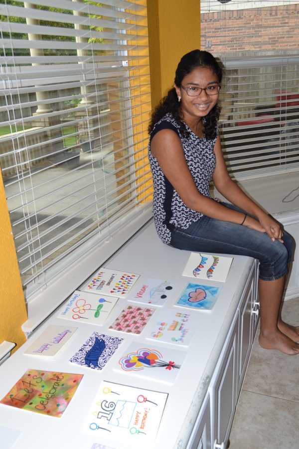 Eilisha and some of her homemade cards, including several made by Special Needs students and adults at Everyday Opportunities.