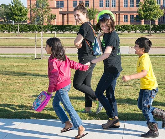 Barsha Darjee and Swastik Sanyasi excitedly make their way towards the Robert Shaw Center upon their arrival. Aided by CRyptonite members Maddison Willmott and Sophie van Dijke, the children are ready to learn more about science concepts such as force and air pressure as a part of their field trip sponsored by the Houston chapter of Sewa. 