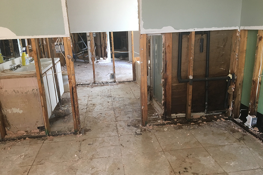In home after home, workers removed damaged sheet rock, wood floors, and other debris following the flooding from Hurricane Harvey.