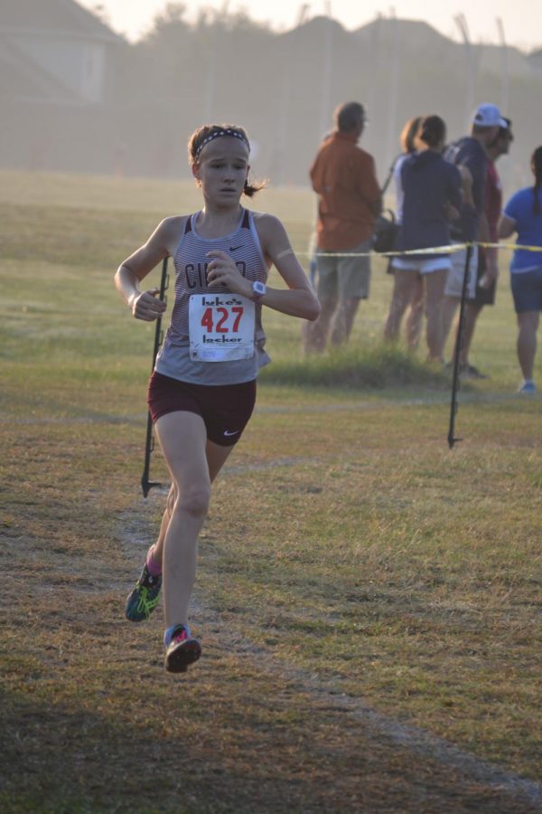 Freshman Heidi Nielson rounds the corner at the UIL 19-6A District Cross Country meet held at Seven Lakes High School  Oct. 23. Nielson placed first in a difficult regional meet, then captured the Regional title in Huntsville and now leads the Cougar team to state Nov. 4.