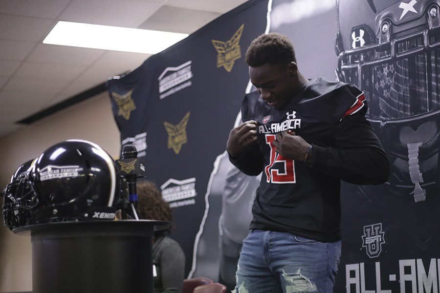 Gbenda tries on his new UnderArmour All-America Team jersey and takes in the moment.