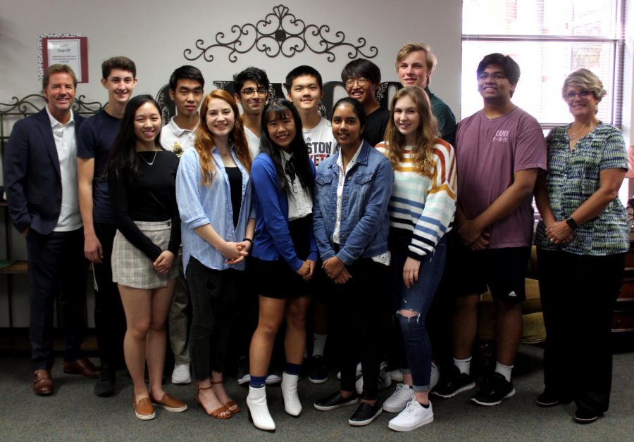 National Merit semifinalists smile beside Principal James Cross (far right) and Senior Assistant Principal Tammy Laurence (far left).