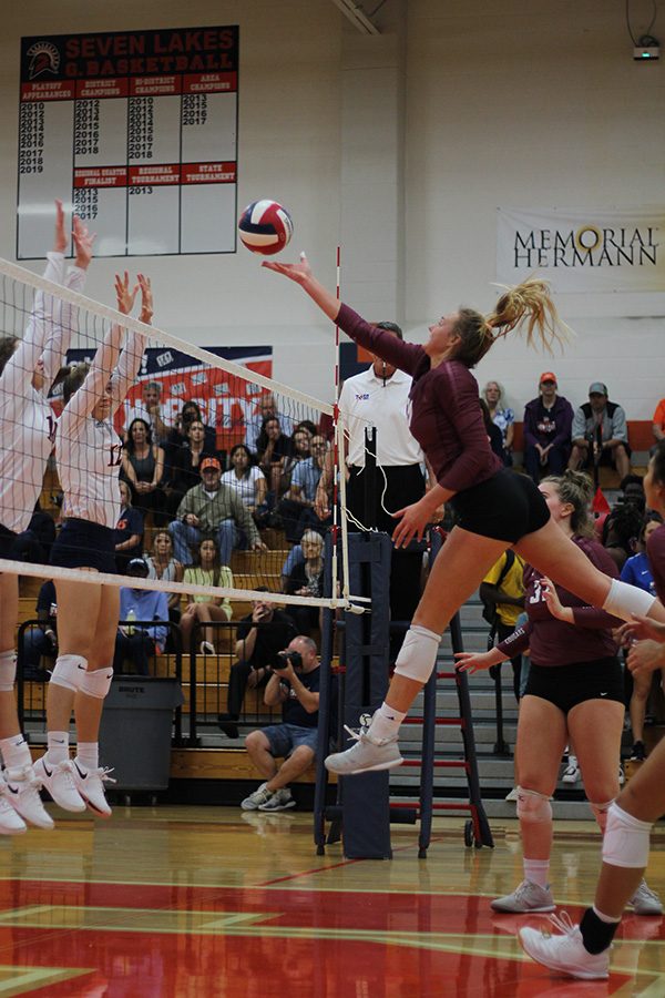 Senior Madalyn OBrien makes an offensive move at the net against Seven Lakes in the first meeting of the two schools Sept. 17. Varsity begins the second half of district play with a 7-0 mark on a top 25 state ranking.