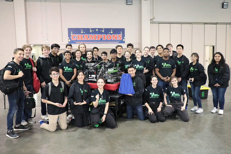 The team poses for a group photo before packing up their robot and leaving the competition venue.